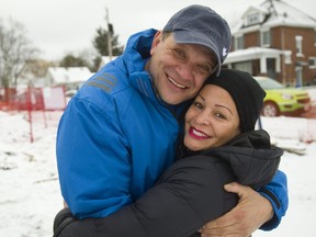 Carlos Munoz hugs his wife Claudia as they arrive at the ground-breaking for their Habitat for Humanity home on Forbes Street. Habitat is building two homes on the site, one for the Munoz family and one accessible home for three men with developmental impairments through Christian Horizons. (MIKE HENSEN, Postmedia News)
