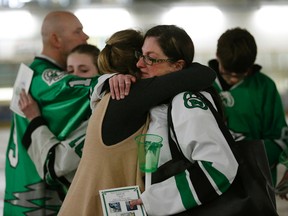 Cory Anne Holmlund (front right) is hugged during a vigil held for former Drayton Valley Thunder hockey player Parker Tobin at the Omniplex in Drayton Valley, Alberta on Tuesday. She was Parker Tobin's billet mother. The hockey player for the SJHL Humboldt Broncos team was one of the players who died in a fatal bus crash when the team bus collided with a semi-trailer on a Saskatchewan highway. Parker Tobin was mistakenly believed to have survived the crash but it was later learned that he had been misidentified with teammate Xavier Labelle, who did survive. Larry Wong/Postmedia Network