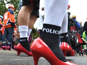 Edmonton Police Service officers are  joined hundreds of high-heeled men ‘step up’ against domestic violence taking part in the annual YWCA Walk a mile in her shoes funding raising event in September .(Ed Kaiser/Postmedia Network)