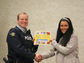 Chelsea Carter (right) of the Rotary Club of Fairview presents Constable Kurt Butler of the Fairview RCMP detachment with a certificate of thanks for his speaking to Rotary. The club made a donation to the fight against Polio in appreciation.