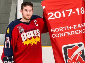 Wellington Dukes team captain Colin Doyle of Campbellford with the 2017-18 OJHL North East Conference playoff championship banner. (OJHL Images)