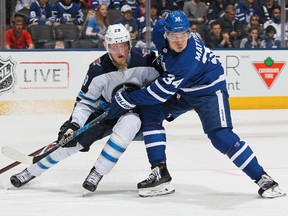 Winnipeg Jets forward Patrik Laine battles Toronto Maple Leafs forward Auston Matthews on March 31. Claus Andersen / Getty Images