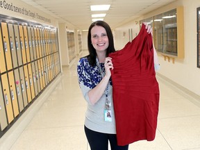Ursuline College Chatham teacher Tasha Sanford displays one of the many quality gently used dresses that will be available for sale at the annual UCC Dress Drive being held on Thursday, May 3, 2018 in the UCC dance studio from 3 p.m. to 7 p.m. Photo taken in Chatham, Ont. on Wednesday April 11, 2018. (Ellwood Shreve/Chatham Daily News)