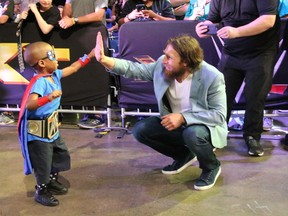 STEVE ARGINTARU/For Postmedia Network
WWE Kid Superstar "Mayhem Maddox" high fives WWE star Daniel Bryan as part of a Kid Superstar Reveal for pediatric cancer survivors at WWE Axxess in New Orleans on Saturday as part of WrestleMania 34 weekend.