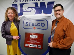 Students at Assumption College in Brantford made this plaque to thank Stelco in Nanticoke for donating $182,000 to upgrade welding education programs at local Catholic and public high schools. Among those in the Nanticoke Industrial Park Wednesday for the unveiling were Allison Hayes, principal of Assumption College, and Rob Malcolm, principal at Waterford District High School. MONTE SONNENBERG / SIMCOE REFORMER