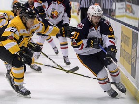 Steph Crosier/The Whig-Standard
Barrie Colts forward Aaron Luchuk takes the puck into the Kingston Frontenacs zone as defenceman Mitchell Byrne keeps an eye on him during first-period action in Game 4 of their Ontario Hockey League Eastern Conference semifinal on Tuesday at the Rogers K-Rock Centre.
