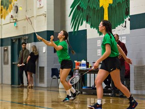 Erika Kunej (left) of North Park Collegiate makes a return as teammate Grace Adams watches during girls doubles play on Wednesday at the Brant County high school junior badminton championships at St. John's College. (Brian Thompson/The Expositor)