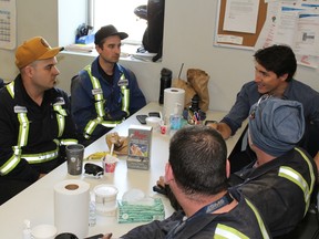 Prime Minister Justin Trudeau speaks with workers at the Fort Hills operation north of Fort McMurray, Alta. on Friday, April 6, 2018. Vincent McDermott/Fort McMurray Today/Postmedia Network