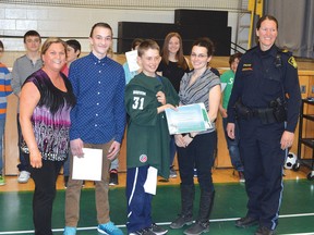 Photo by KEVIN McSHEFFREY/THE STANDARD
Blind River’s École St-Joseph principal (far left) Julie Chenard Azzi recently presented Alexandre Boivin (centre) with a certificate and a school hockey team jersey. They were joined by fellow team member Roch Lemieux, team trainer Michelle Gagnon and OPP Sergeant Zenobie Ney.