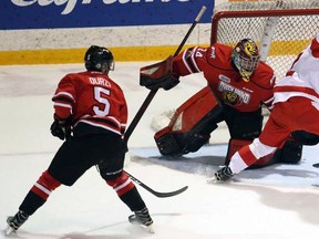 Soo Greyhounds defenceman Noah Carroll brings the puck in on Owen Sound Attack goaltender Olivier Lafreniere, tailed by Attack defenceman Sean Durzi, during OHL playoff action Wednesday evening in Owen Sound. Greg Cowan/Postmedia Network