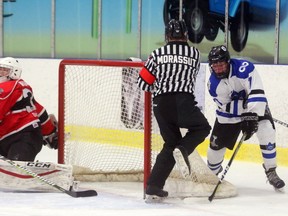 Luke Drewitt of London Nationals, has Listowel Cyclones goalie Max Wright out of position on a wrap around but for a ill-placed skate belonging to referee Jake Morassut during the first period Sutherland Cup semifinal at the Western Fair Sports Centre in London. The Nationals led 2-0 in the first period. (Mike Hensen/Postmedia Network)