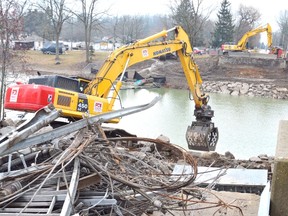 Excavators at the site of the Port Bruce bridge which collapsed amidst heavy rainfall and melting Feb. 23. (Louis Pin/Times-Journal)