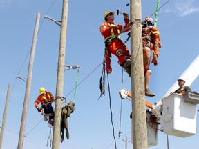 Cole Haggins, left, and Noah Glos, both 21-year-old second-year powerline students take part in the pole top rescue during the St. Clair Powerline Rodeo held in Chatham, Ont. on Thursday April 12, 2018. (Ellwood Shreve/Chatham Daily News)