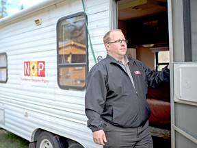 Trevor Holliday, leader of the Northern Ontario Party (NOP) poses for a portrait with his campaign trailer at his home in Callander. 
Tyler Anderson / Postmedia