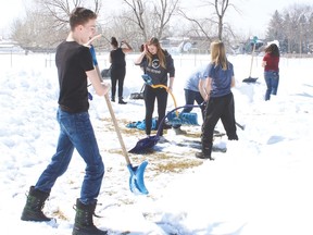 County Central High School rugby players shovelled snow off the ConocoPhillips Sportsfield Friday