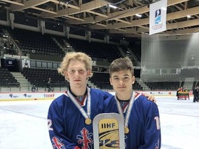 Edward Bradley and Patrick Larkin pose for a photo after winning gold with Great Britain at the Division II Group A U18 World Championship. CIHA Academy photo