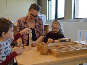 Courtney Rudd, child care supervisor at the YMCA’s newly-reopened Balsam Street Centre, chats with Lincoln Lavoie, left, and Nevaeh Partington as they interact with wooden blocks and toys. The new child-care centre has more spaces for children, as well as new equipment. Rudd says the spaces are calming and promote children’s independence.