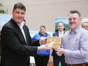 Richard Eberhardt, Program Director for Green Economy North, presents Adam Eusepi of Morin Industrial Coatings Ltd with the new member of the year award in Sudbury, Ont. on Thursday April 12, 2018. Green Economy North celebrated environmental leaders  at their second annual Evening of Recognition. Gino Donato/Sudbury Star/Postmedia Network