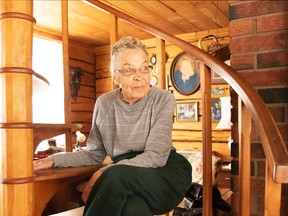 Ellen Lehtela shows off the beautiful staircase she had made many decades ago. In the background is her portrait. Mary Katherine Keown/The Sudbury Star