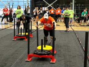 Chatham-Kent firefighter Ian Warren, right, and Chatham-Kent OPP recruit Shelton Richardson, give it their all while competing in the second annual Clash of the Sirens, held at the St. Clair Colleg Healthplex in Chatham, Ont. on Saturday April 14, 2018. Ellwood Shreve/Chatham Daily News/Postmedia Network