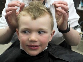 BRIAN KELLY/Sault Star
Catherine Moore puts gel in the hair of Douglas Downs, 6, during the 11th annual Cuts for the Cause at Catherine's Hairstyling and Barbershop on Saturday. Moore and Kristyn Rathbone teamed up to organize this year's fundraiser to help Sault Ste. Marie Humane Society. “We have been very steady all morning long,” said Moore. “Not a lot of down time.” All fees charged for hair care services are donated to the animal shelter. Visitors also dropped of bags of food, toys and bedding to help the humane society. This is the last year for Cuts for the Cause at Catherine's current location. The business is moving to Bruce Street.