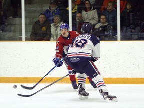 Rayside-Balfour Canadians' Noah Serre (12) looks to make a pass while Cochrane Crunch's Gordon Whalen defends during NOJHL action at Chelmsford Arena on Saturday, April 14, 2018. Ben Leeson/The Sudbury Star/Postmedia Network