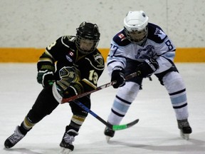 London Jr. Knights player Nicholas Mangialardi and North Bay Major Atom AA Trappers' Simon Toupin battle for the puck during OHF championship round-robin action at the Sam Jacks Recreation Complex, Saturday. London edged North Bay in the semifinal Sunday 4-3 after the two teams had skated to a 1-1 tie in their preliminary round match. Dave Dale / The Nugget