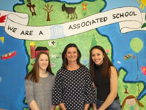 Morgan Clark (left) and Christianna Reimer-Catteau (right), Grade 9 students at Bruce Peninsula District School, and Terri Munn, a BPDS teacher who will join the students at a national UNESCO schools conference, posed for a photo at their school in Lion’s Head, April 10. The trio heads to Winnipeg to present their school's climate change project at the conference from April 25-27. Photo by Zoe Kessler/Wiarton Echo