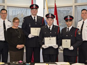 Brantford Police Chief Geoff Nelson (left), police services board chair Deb Cockerill and deputy chief Rob Dinner (right) presented exemplary service awards to constables Matt Roberts (centre), Jacob Campbell and A.J. Snively  on Thursday. Roberts and Campbell rescued an emotionally-distraught man from a vehicle running in a closed garage, requiring treatment afterwards for carbon monoxide exposure. Snively applied a tourniquet to a woman's arm to stop arterial bleeding until EMS personnel arrived. 
Brian Thompson/The Expositor