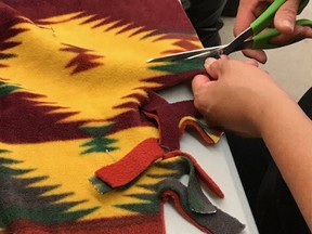 A member of the Tyendinaga Mohawk Territory cancer talking circle works on a healing blanket. (Supplied Photo)