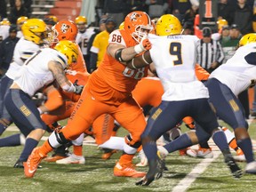 North Bay's Ryan Hunter (68) blocks a Toledo Rockets player during his last NCAA Div. 1 game for the Bowling Green Falcons last fall. Hunter, an offensive lineman with guard, tackle and centre experience is ranked No. 1 in the CFL draft coming May 3 but he's hoping to get a chance in the NFL which has its draft April 28. Denis Lacourse Photo