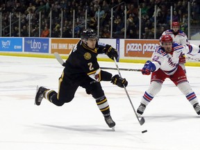 Sarnia Sting forward Theo Calvas, left, lets go a shot while the Sting were killing a penalty as Kitchener Rangers forward Adam Mascherin gives chase in Sarnia, Ont. on Sunday April 15, 2018 during Game 6 of their Ontario Hockey League semifinal series. (Greg Colgan/Postmedia Network)