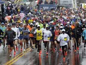 The field of men's elite runners leave the starting line in the 122nd Boston Marathon on Monday, April 16, 2018, in Hopkinton, Mass. (AP Photo/Steven Senne) ORG XMIT: BX112