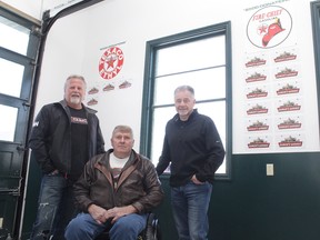 KEVIN RUSHWORTH HIGH RIVER TIMES/POSTMEDIA NETWORK. Building efforts are ongoing at the historic Eamon's service station at the High River Agricultural Grounds. Pictured from left to right are Jeff Langford, Brian Chipchase and Don Horn under the station's donor wall.