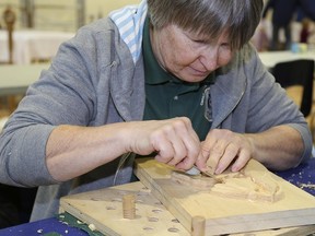 TIM MEEKS/THE INTELLIGENCER
Heike Koch of Mount Albert, near East Gwillumbury, carves a floral display into a piece of wood during the Quinte Wood Carvers Association annual show and competition Saturday at the Quinrte Sports and Wellness Centre.
