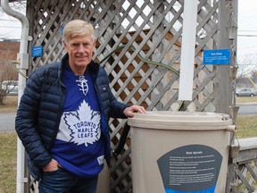 Jim Keech, Utilities Kingston's president and CEO, sports a Toronto Maple Leafs jersey in support of the Humboldt Broncos on Thursday as he turns over one of the rain barrels from being winterized in the Water Conservation Garden outside the offices on John Counter Boulevard. (Julia McKay/The Whig-Standard)