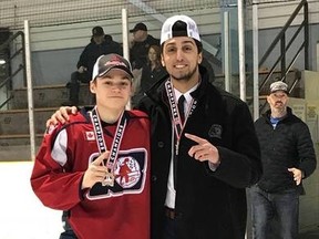 North Bay Minor Midget Trappers assistant coach Calvin Gomes and Tanner Flood after Northern Cup victory in Sault Ste. Marie in March 2018.