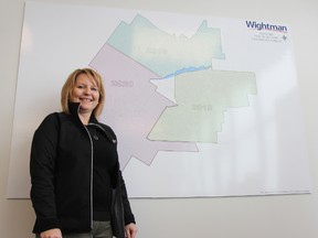 Janelle Huber, customer service representative with Wightman Telecom, stands next to a Stratford map showing the years in which parts of the city will have fibre optic service available to residents. JONATHAN JUHA/THE BEACON HERALD/POSTMEDIA NETWORK