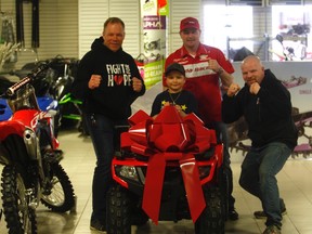 Gordon Anderson Daily-Herald Tribune
(Left to right clockwise) Raphael Bergmann, Myles Longphee, Scott Cartwright and Jordan Cartwright gather around a brand-new Honda quad Jordan received as a birthday gift from Grande Prairie Honda and Power Sports. Scott Cartwright, along with his wife Robyn (not pictured), created the Fight For Hope boxing card, an event set to debut next Saturday night at the Crosslink County Sportsplex. All the proceeds go to the Ronald McDonald House and Kids With Cancer Society.