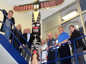 These Tecumseh Secondary School grads are among those who support keeping the totem pole, created by four students in the early 1970s, a part of the Chatham school. Photo taken in Chatham, Ont. on Monday April 16, 2018. (Ellwood Shreve/Chatham Daily News/Postmedia Network)
