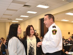 Human trafficking survivors Timea Nagy, left, and Natasha Falle talk with Owen Sound police acting-Insp. Mike Daze at a Human Trafficking Conference at the Harry Lumley Bayshore Community Centre on Tuesday, April 17, 2018 in Owen Sound, Ont. Both women spoke at the conference, which was attended by about 200 people, including police, health and social services agencies, school boards and other groups. The two-day conference continues on Wednesday. (Rob Gowan The Sun Times)