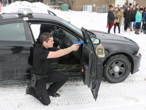 Police Foundations student Carl Black of Timmins takes aim at an armed suspect during a mock scenario carried out at Northern College on Tuesday. The event was part of a training exercise as well as a demonstration for secondary school students who might be interested in attending the college at some point in the future.