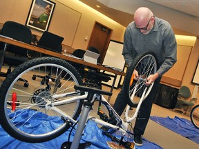 Bryce Eger, the Canadian commercial unit leader for Corteva Agriscience (the agriculture division of DowDuPont) assembles a bike to donate to the Chatham-Kent Children's Treatment Centre at the DuPont Pioneer offices on Queen's Line just outside of Chatham on April 10. Tom Morrison/Chatham This Week