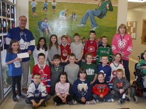 Above, Grades 2-3 presents McDonald’s Exeter owner Rob Reid a cheque for $524.45 on April 12. The money was raised through the indoor yard sale. (William Proulx/Exeter Lakeshore Times-Advance)