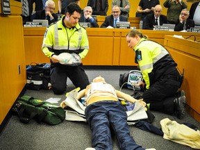 Huron County Council watch while Huron County Paramedics, Adam Robinson and Cassie Crawford, give a demonstration of the Zoll Medical AutoPulse Resuscitation System. (Jenna Ujiye)