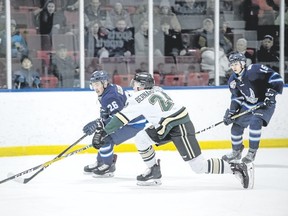 Okotoks Oilers’ Jacob Bernard-Docker stretches to reach the puck before Canmore Eagle’ Max Giangualano during an AJHL game at the Canmore Recreation Centre on Thursday, March 1, 2018. Pam Doyle/ pamdoylephoto.com