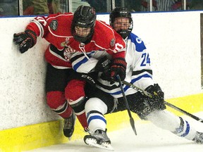 Listowel Cyclones' Bryce McFadden is rubbed out along the boards by Nationals forward Colin Wilson during the first period of Game 5 of the Sutherland Cup semifinal at the Western Fair Sports Centre in London on Wednesday. Derek Ruttan/The London Free Press