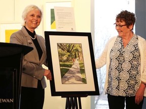 From left, Mayor Gale Katchur stands beside the chosen painting for this year’s 2017 Art in Public Places program along with the artist who made the painting Linda Morrow on Monday, April 16.