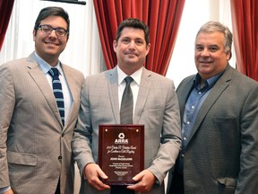 John McClelland, Perth County’s director of public works, accepted the Asphalt Recycling and Reclaiming Association’s annual Charles R. Valentine Award for Excellence in Cold Recycling at Thursday’s county council meeting. The award was presented to McClelland by Nicholas Cifelli (left), a technical services manager specializing in pavement products at The Miller Group, and Bentley Ehgoetz (right), a former director of public works for Perth County and the current director of operations for Lavis Contracting. (Galen Simmons/The Beacon Herald)