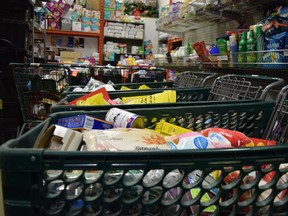 Shopping carts filled with canned and packaged food crowd a corner of the Wood Buffalo Food Bank's warehouse in Fort McMurray, Alta. on Tuesday, April 4, 2017. Cullen Bird/Fort McMurray Today/Postmedia Network